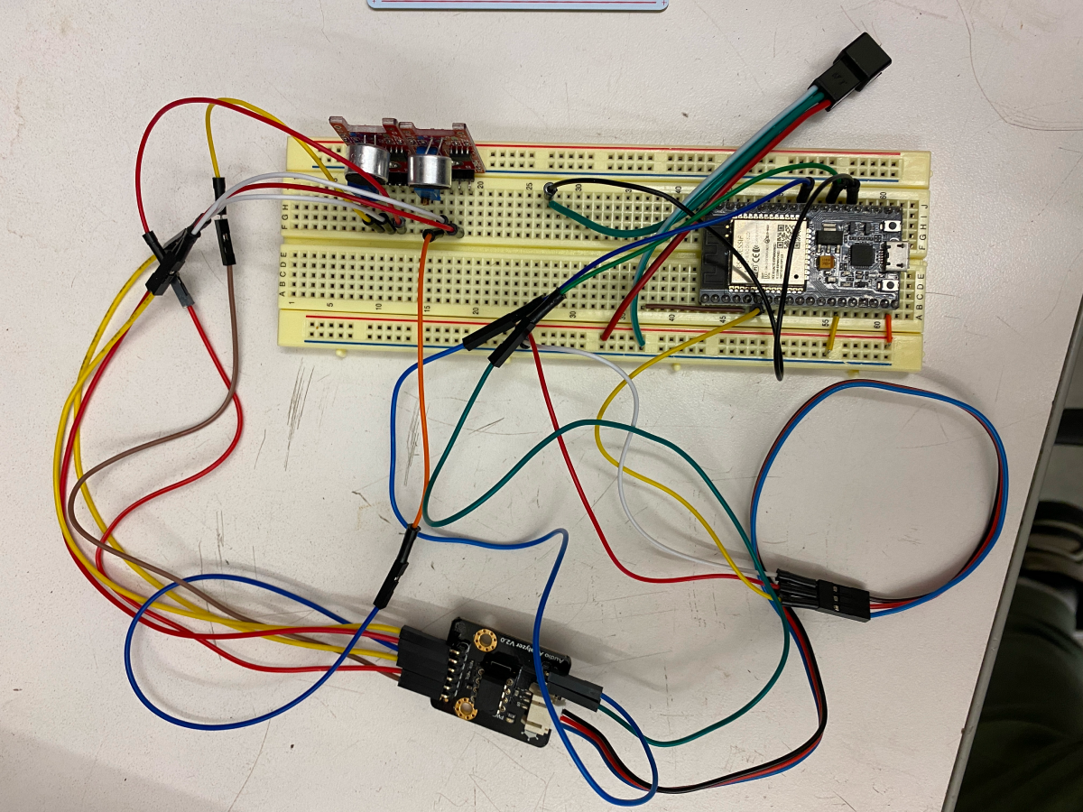 Breadboard wired to a microcontroller and small microphones